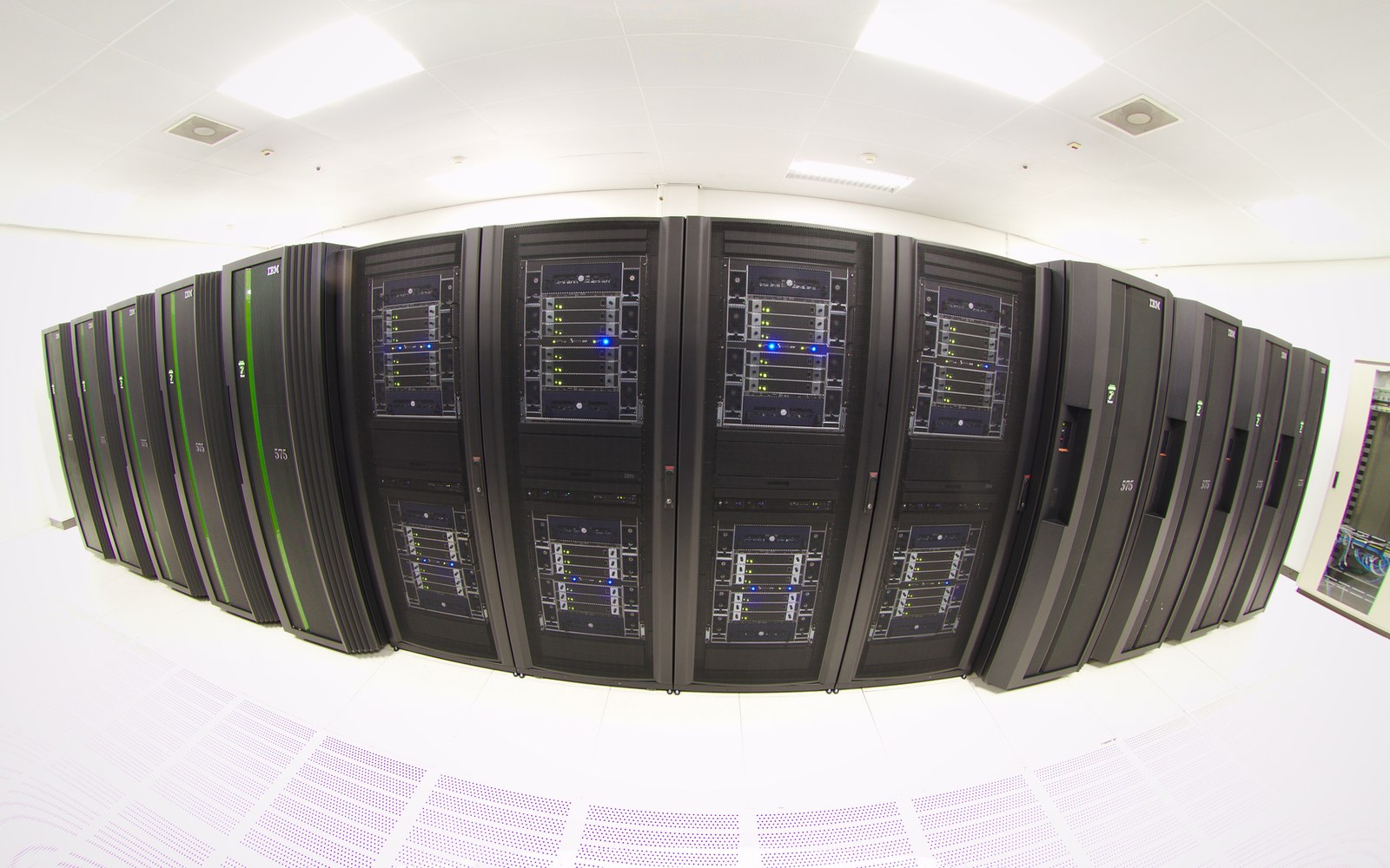 Rows of black server racks with blinking indicator lights in a data center
